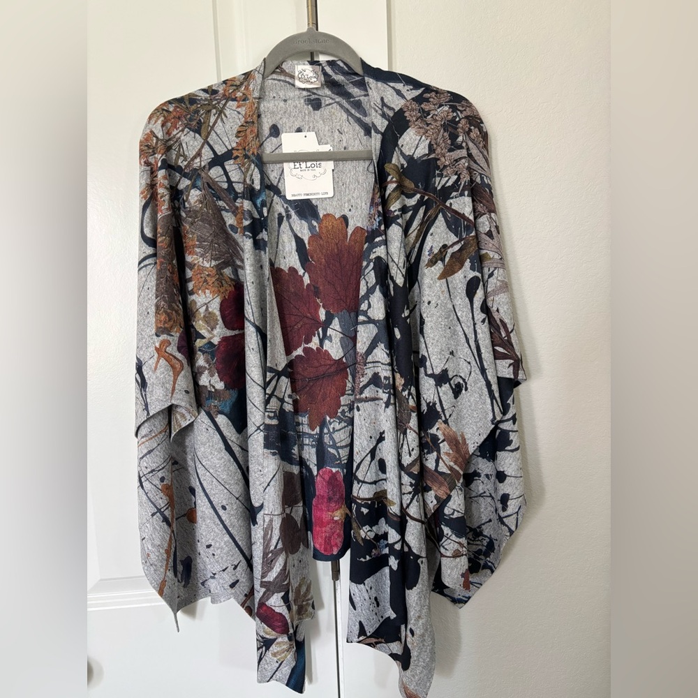 Et’ Lois soft knit open wrap/shawl features a botanical foliage
